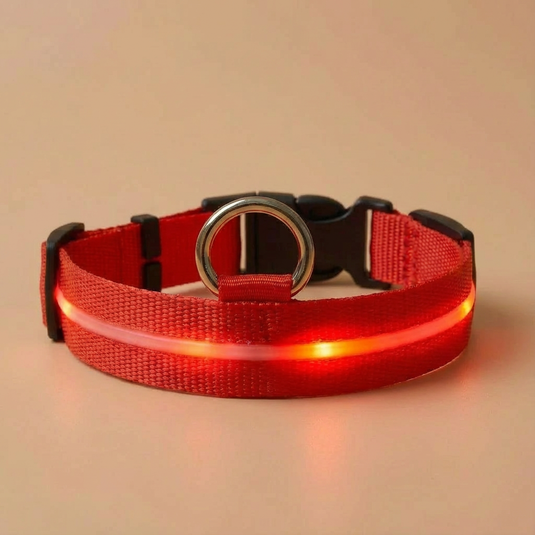 Red LED dog collar on a beige background